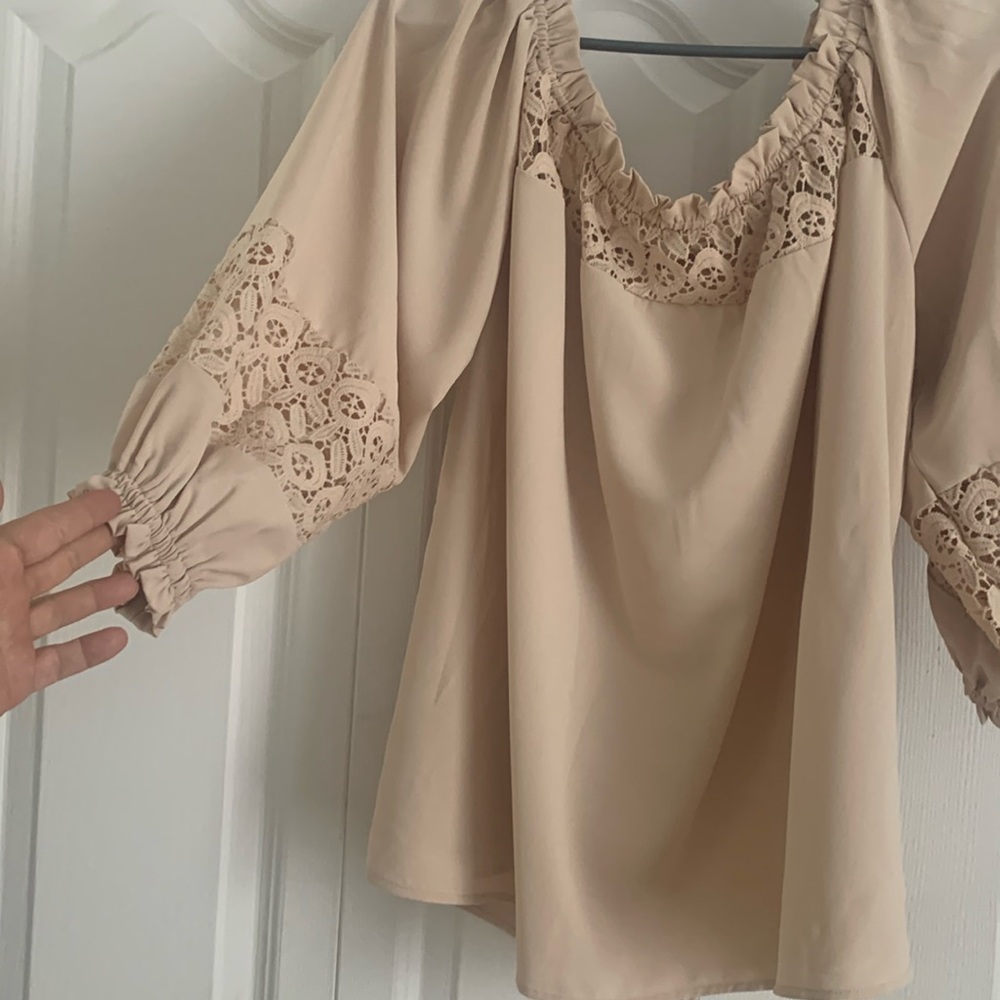 Brand new ! Beautiful top with lace detail on top and sleeves , very feminine.